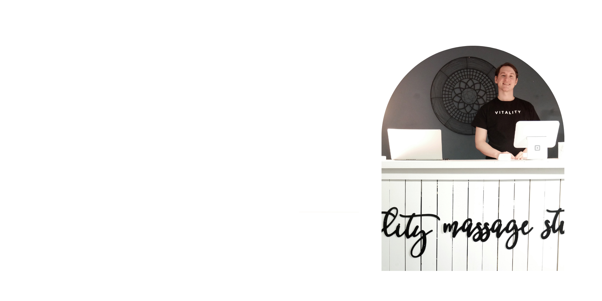 Andrew Radi, standing at front desk at Vitality Massage Studio